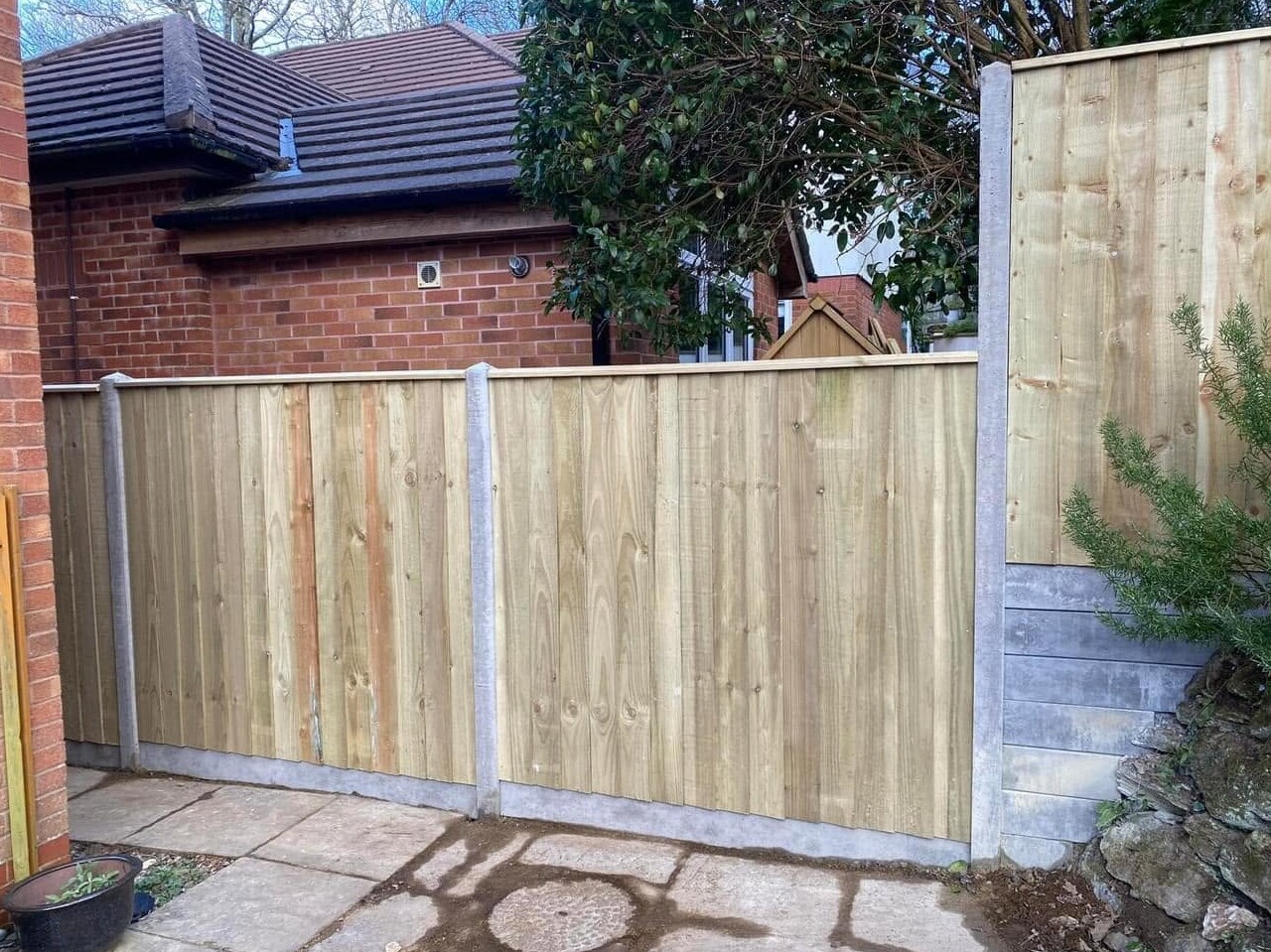 Timber closeboard fencing installed on concrete posts and gravel boards